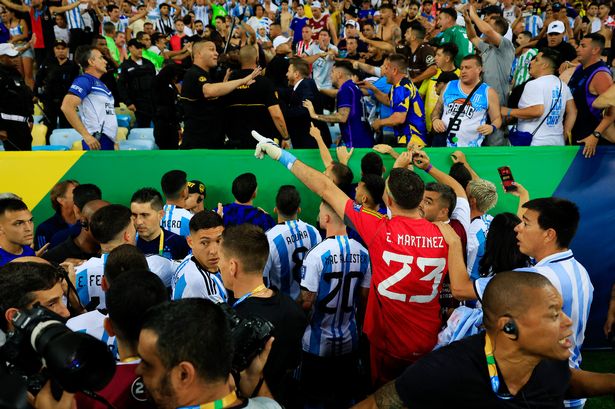 Emiliano Martinez of Argentina and teammates react as police officers clash with fans prior to a FIFA World Cup 2026 Qualifier match with Brazil.